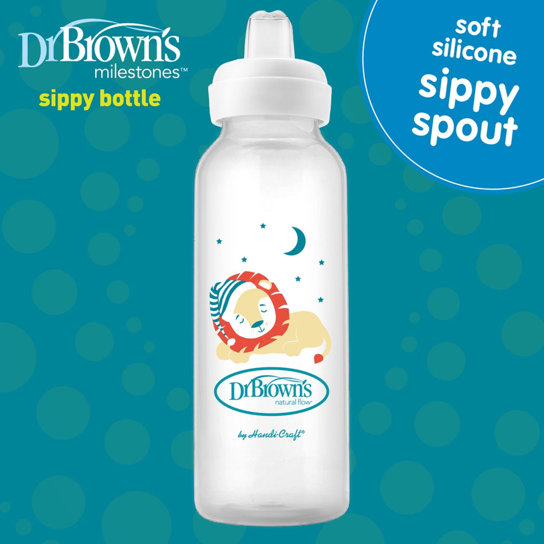 Dr. Brown's® Milestones™ Narrow Sippy Bottle, 8oz/250mL, features a soft silicone spout and a clear body with a serene depiction of a sleeping lion resting on a moon surrounded by stars, celebrating baby's milestones. The phrase "Soft silicone sippy spout" is prominently displayed at the top right corner against a blue backdrop with lighter circles. Designed for infants 6 months and older.