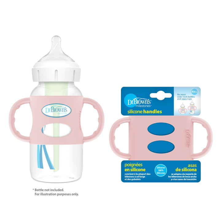 A Dr. Brown's baby bottle with pink Dr. Brown’s® Milestones™ Wide-Neck Silicone Handles is positioned beside a packaged set of these silicone handles, which are ideal for nurturing independent drinking skills. The packaging shows the product name in both English and Spanish and highlights a design that ensures easy gripping. Please note: bottle not included.