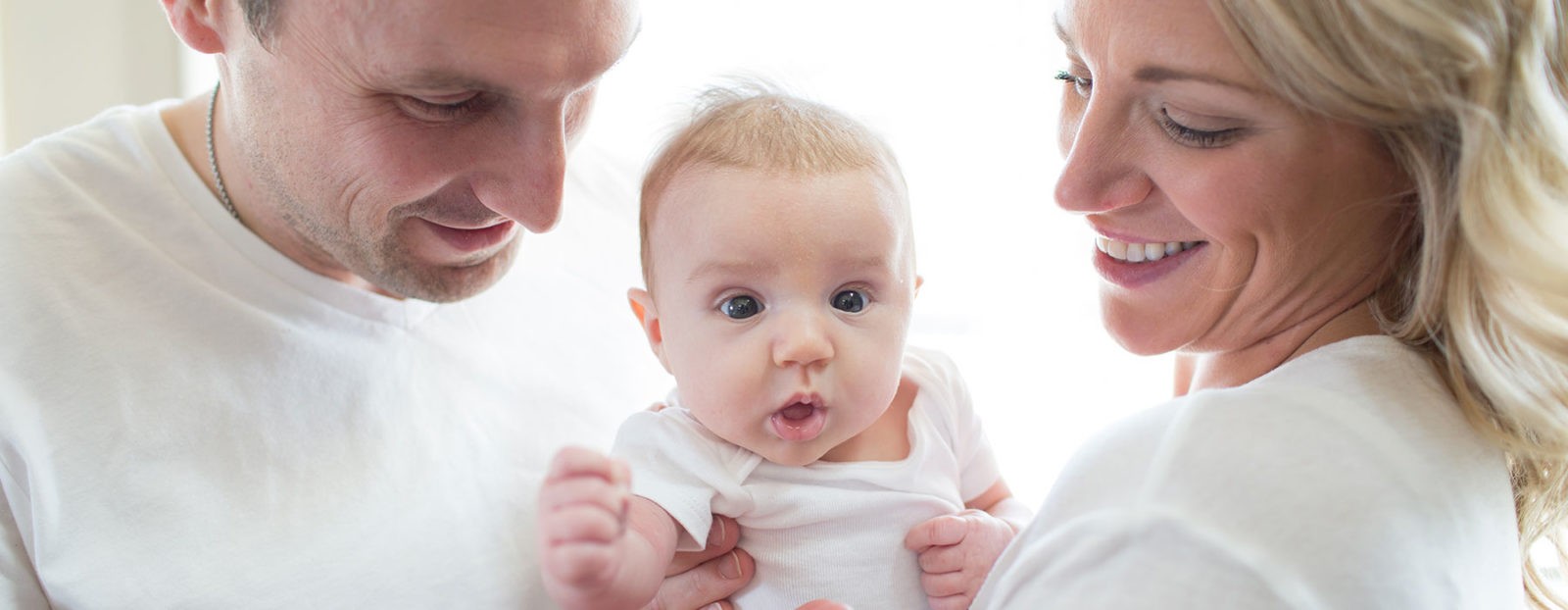 Dad, baby and Mom family photo - Dr. Brown's