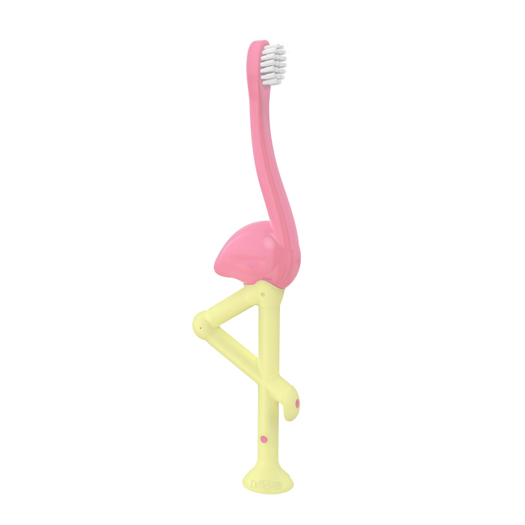 A toothbrush for toddlers from Dr. Brown's, the Flamingo design, showcases super-soft bristles and a charming pink body accented with yellow legs as the handle. It elegantly balances on one leg and includes a sturdy suction-cup base, ensuring that brushing is both enjoyable and simple for young children.