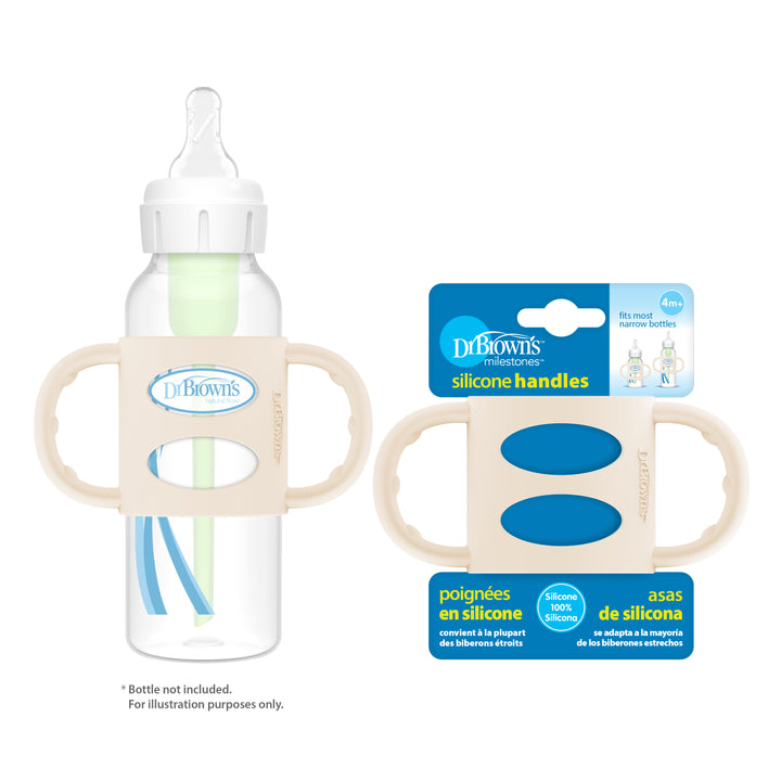 The Dr. Brown’s® Milestones™ Narrow Silicone Handles in beige are attached to the baby bottle and positioned next to their packaging. These handles encourage independent drinking and are compatible with most narrow bottles. The packaging includes information in English, French, and Spanish.