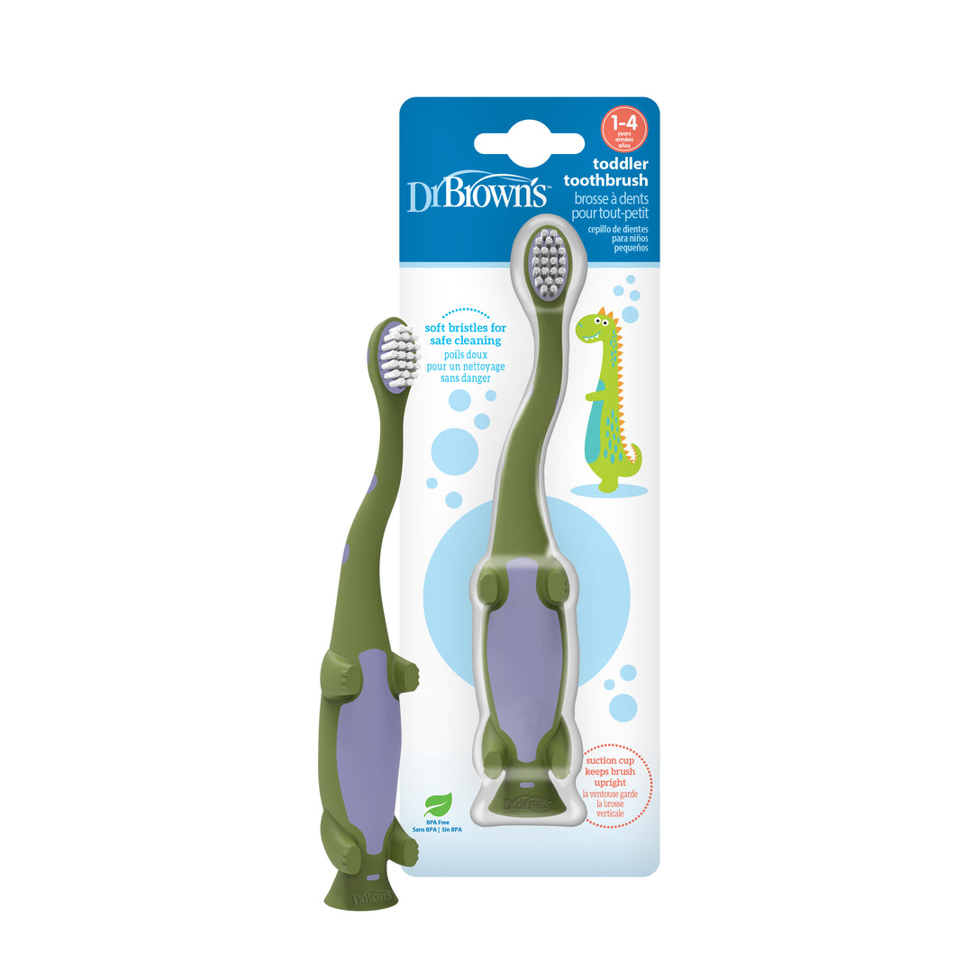 Dr. Brown's Dinosaur Toddler Toothbrush pack, in a charming green hue, showcases two playful dinosaur-shaped toothbrushes. Crafted to encourage independent brushing, the packaging adorned with a whimsical dinosaur design emphasizes its appropriateness for children aged 1 to 4, promoting excellent oral hygiene habits from an early age.