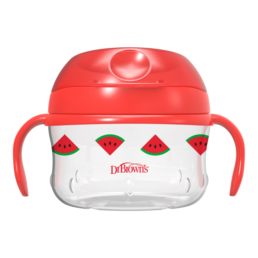 The Dr. Brown's™ Designed to Nourish™ Snack Cup is a clear, spill-proof sippy cup featuring flexible flaps and decorated with watermelon slice graphics. It has red handles and lid, ideal for toddler snacks on the move, with the brand name "Dr Brown's" elegantly printed on its body.