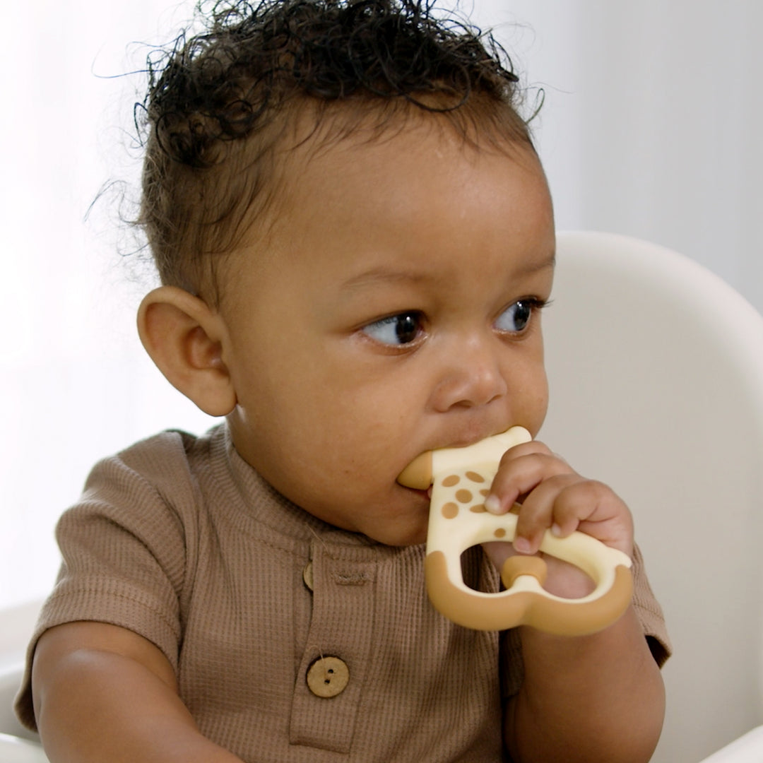 Baby chewing on ridgees giraffe teether