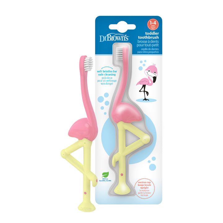 The Dr. Brown’s™ Toddler Toothbrush, Flamingo, 1-Pack is a toothbrush designed for toddlers aged 1-4. It features a pink flamingo shape with super-soft bristles and a yellow handle on its leg. The packaging proudly displays the "Dr. Brown's" brand name and includes a handy suction-cup base for convenient storage.