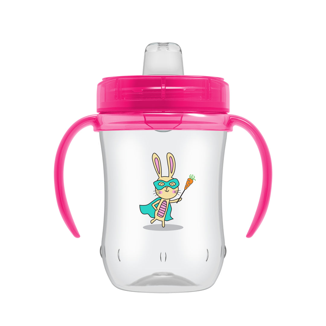 Introducing the Dr. Brown’s® Soft-Spout Toddler Cup, a spill-free learning cup designed for children 9 months and older. Featuring pink handles and lid, this 9 oz/270 ml cup includes a playful superhero rabbit illustration complete with a mask, cape, and carrot. Its soft silicone spout makes it ideal for transitioning from bottle to cup.