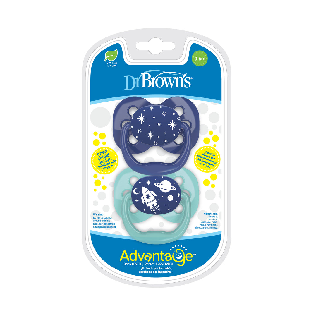 Package of two Dr. Brown’s™ Advantage™ Pacifiers by Dr. Brown's for babies aged 0-6 months includes a dark blue pacifier with an outer space theme and a light blue pacifier with a coordinating design. The symmetrical shape is crafted from baby-safe materials, and the package carries the label "Baby Tested, Parent Approved.