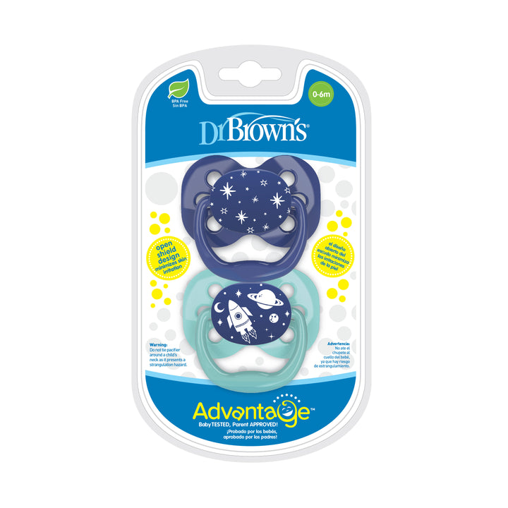 Package of two Dr. Brown’s™ Advantage™ Pacifiers by Dr. Brown's for babies aged 0-6 months includes a dark blue pacifier with an outer space theme and a light blue pacifier with a coordinating design. The symmetrical shape is crafted from baby-safe materials, and the package carries the label "Baby Tested, Parent Approved.