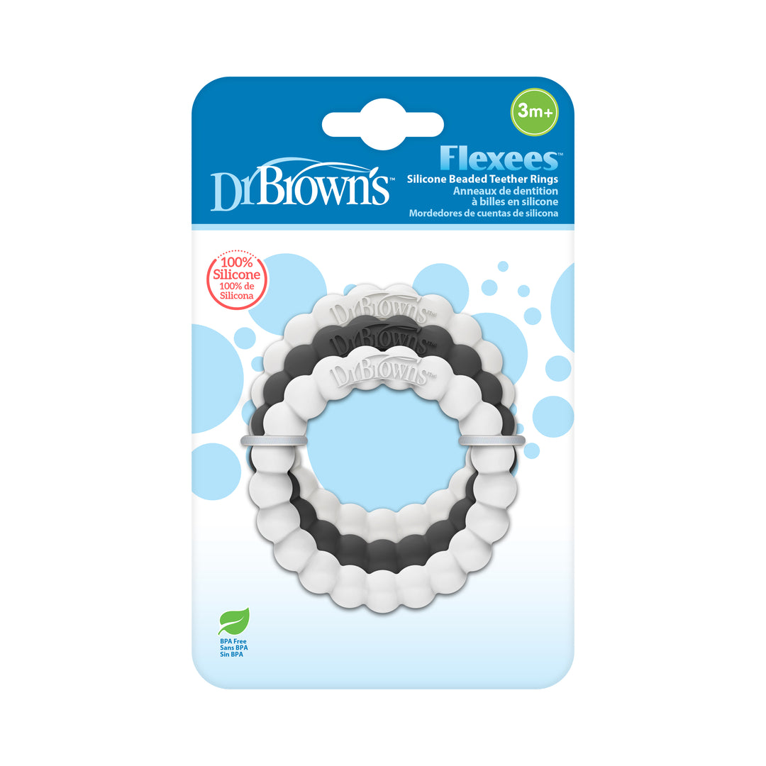 Displayed in their packaging, Dr. Brown’s™ Flexees™ Beaded Teether Rings are available in black, white, and gray. Specially designed to relieve teething pain for babies 3 months and older, these rings are crafted from 100% silicone to aid in self-soothing.