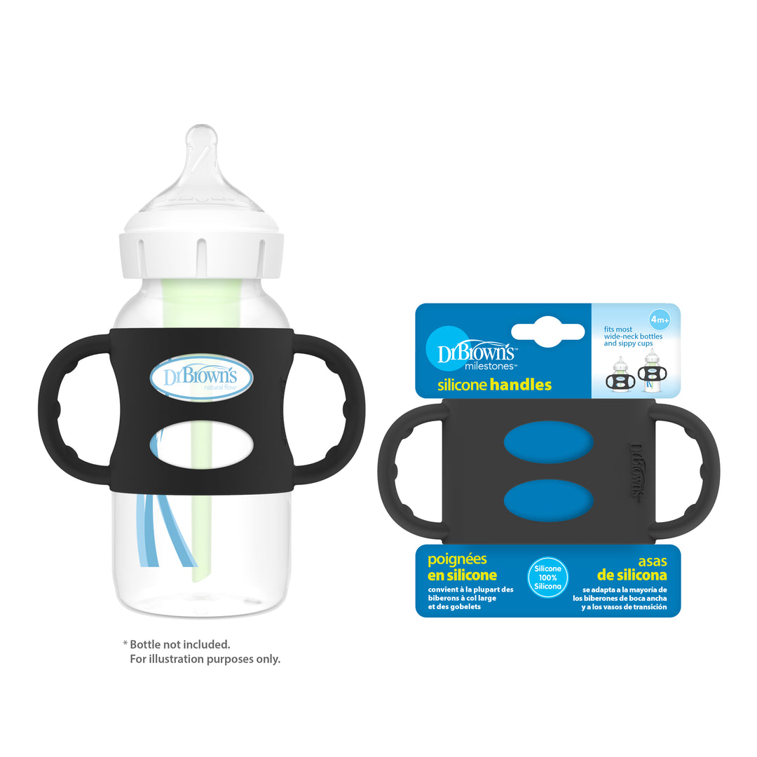 A clear baby bottle with a white nipple, complemented by Dr. Brown’s® Milestones™ Wide-Neck Silicone Handles in black, promotes independent drinking for young children. Beside it is the packaging for these Dr. Brown's silicone handles, showcasing blue accents and bilingual text in English and Spanish.