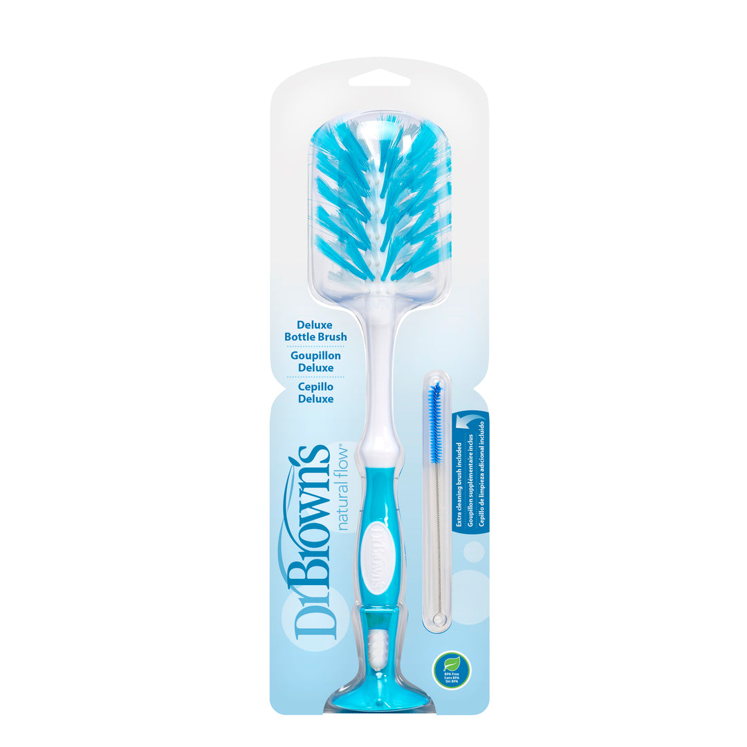 Dr. Brown's Natural Flow® Deluxe Bottle Brush packaging features a large blue and white brush with a curved handle, soft bristles, and a BPA-free smaller blue nipple cleaner. The branding and product details are clearly visible.