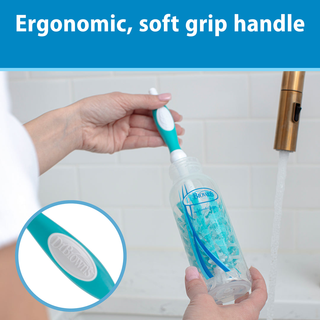 A person cleans a baby bottle under a faucet using Dr. Brown’s Natural Flow® Deluxe Bottle Brush in blue and white. The brush is BPA-free with an ergonomic, soft grip handle and includes an integrated nipple cleaner for convenience. A close-up highlights its efficient cleaning power.