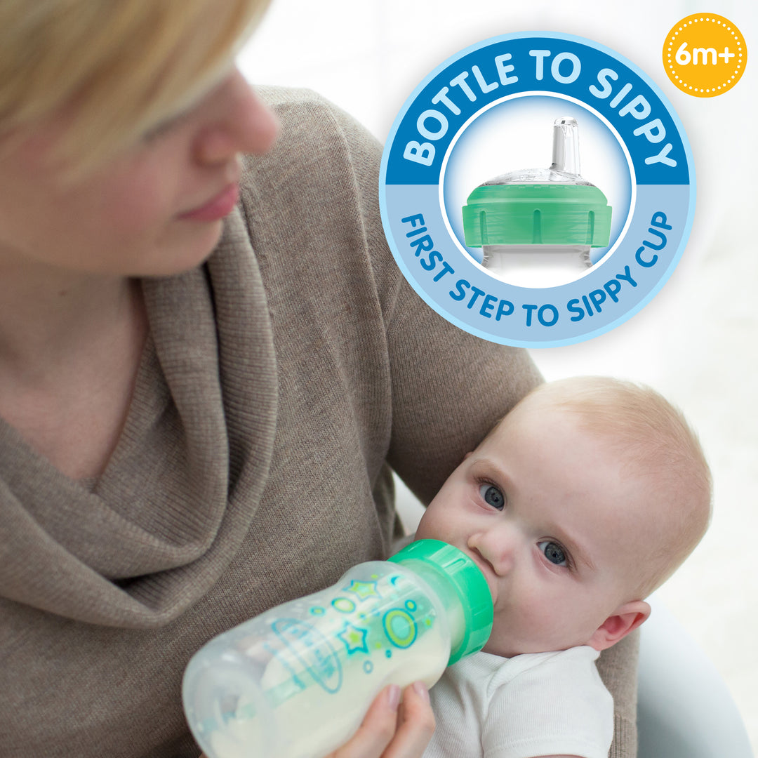 A caregiver gently holds a baby using the Dr. Brown’s Natural Flow® Anti-Colic Options+™ Wide-Neck Sippy Bottle Starter Kit, featuring a green lid. A round label states, "Bottle to Sippy, First Step to Sippy Cup," emphasizing its anti-colic features and recommending it for ages 6 months and up as an ideal transition kit.