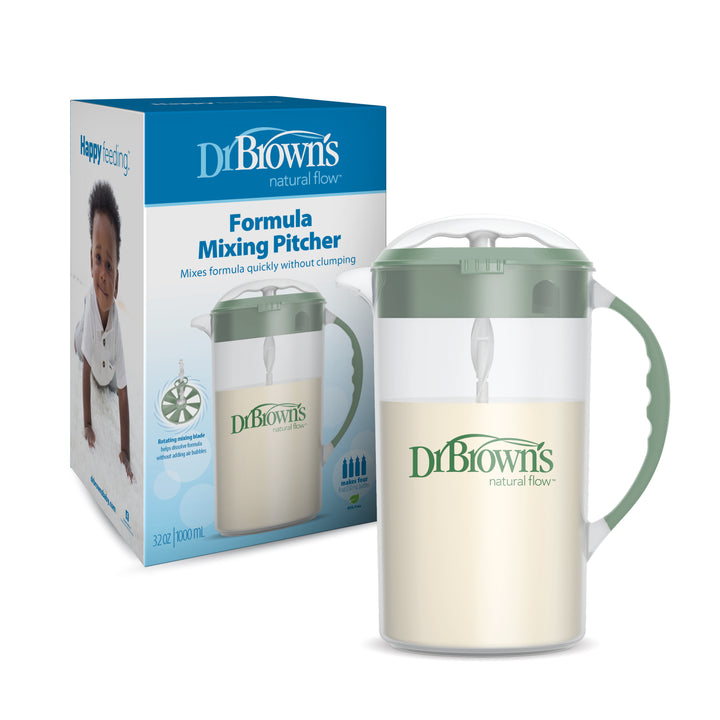 The Dr. Brown's Natural Flow® Formula Mixing Pitcher comes with its packaging, ideal for effortless formula preparation. The clear pitcher features a green lid and handle, while the box displays a crawling baby and emphasizes its compatibility with baby bottles.