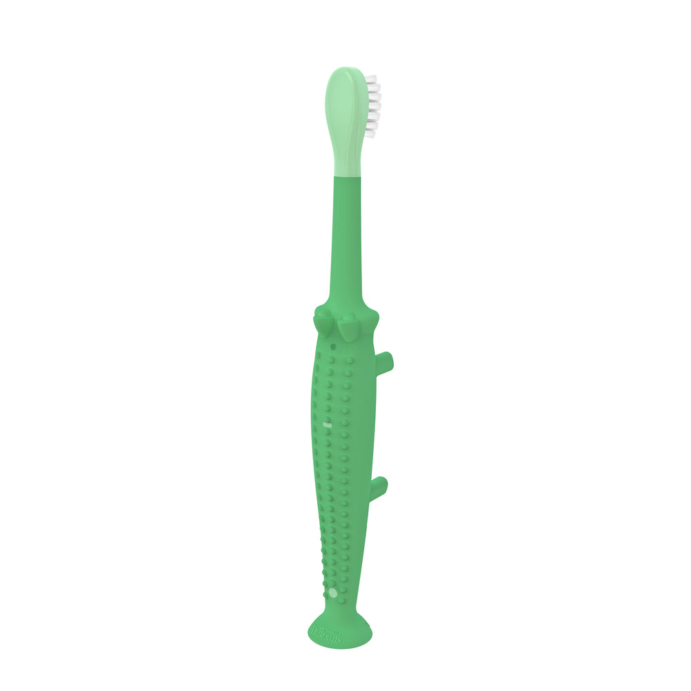 Dr. Brown's Dr. Brown’s™ Toddler Toothbrush in the shape of a green crocodile features super-soft bristles and a textured grip, and it stands upright on a convenient suction-cup base.