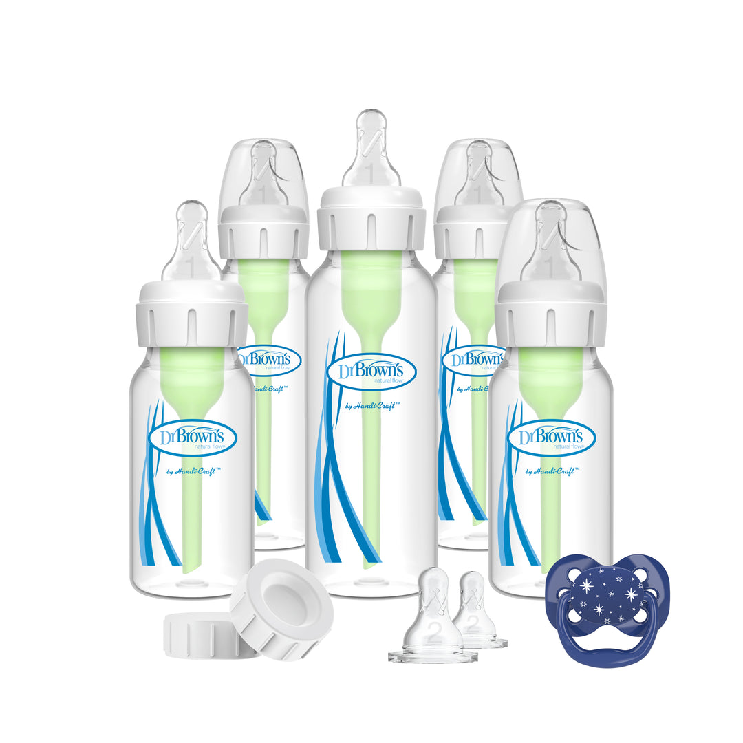 The Dr. Brown's Natural Flow® Anti-Colic Options+™ Narrow Baby Bottle Gift Set includes five baby bottles with green internal vents, clear tops, and a blue logo. The set also comes with silicone nipples, bottle caps, and a blue Advantage™ Pacifier featuring star and moon designs.