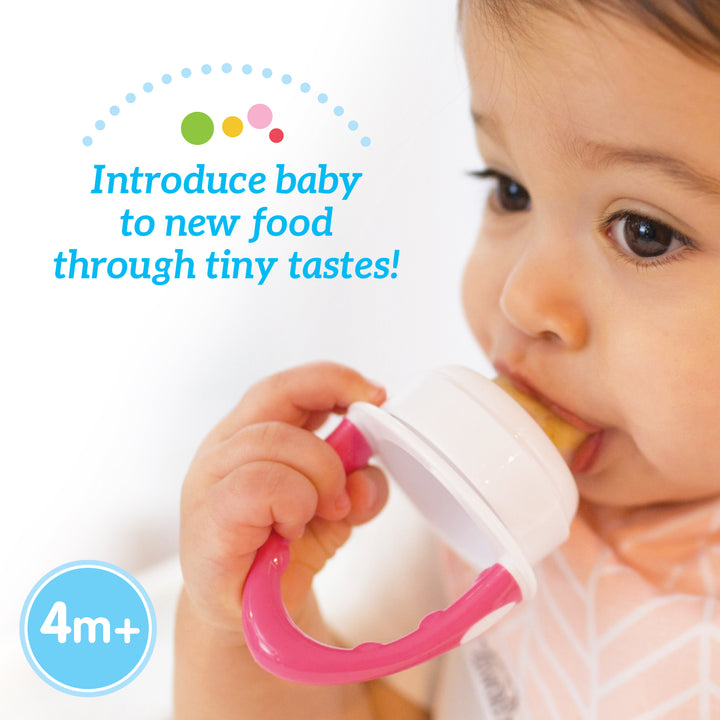 A baby is exploring new foods with Dr. Brown's™ Fresh Firsts™ Silicone Feeder, which features a white top and a pink handle. The image reads, "Introduce baby to new food through tiny tastes, 4m+." Ideal for Fresh Firsts!