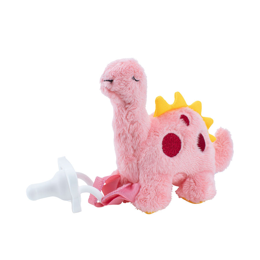 A soft, pink dinosaur plush toy from Dr. Brown's with yellow spikes and red spots is attached to the white Dr. Brown’s® Lovey Pacifier and Teether Holder by a pink strap. This comforting pacifier holder features a long neck and small tail, making it perfect for soothing a baby.