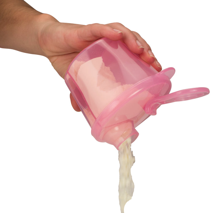 A hand is holding Dr. Brown’s® Baby Formula Dispenser, a pink container with compartments, pouring white powder through its spout. The dispenser from Dr. Brown's has an attached lid, set against a plain white background.