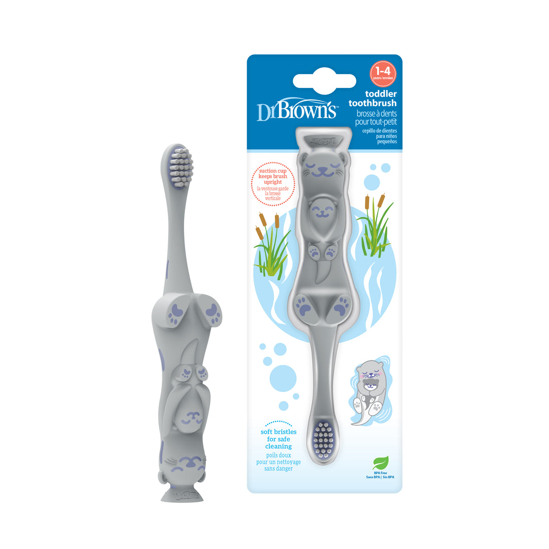 The Dr. Brown's Otter Toddler Toothbrush is a toddler toothbrush designed like a cat, featuring gray coloring, facial features, and paws for playful oral hygiene. The packaging highlights the "Dr. Brown's" brand with adorable illustrations of a cat and a pond. Ideal for ages 1-4, it promotes independent brushing with its soft bristles and includes a convenient suction cup for storage.