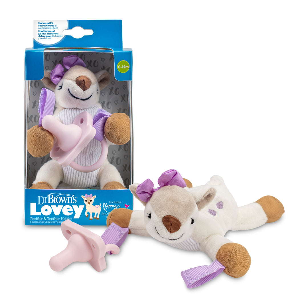 A plush deer toy adorned with a purple bow and spots is connected to Dr. Brown’s HappyPaci and showcased beside its packaging, which reads "Dr. Brown’s® Lovey Pacifier and Teether Holder, Deer," featuring a matching design. Perfect for infants aged 0-12 months, this adorable companion also functions as a convenient teether holder.