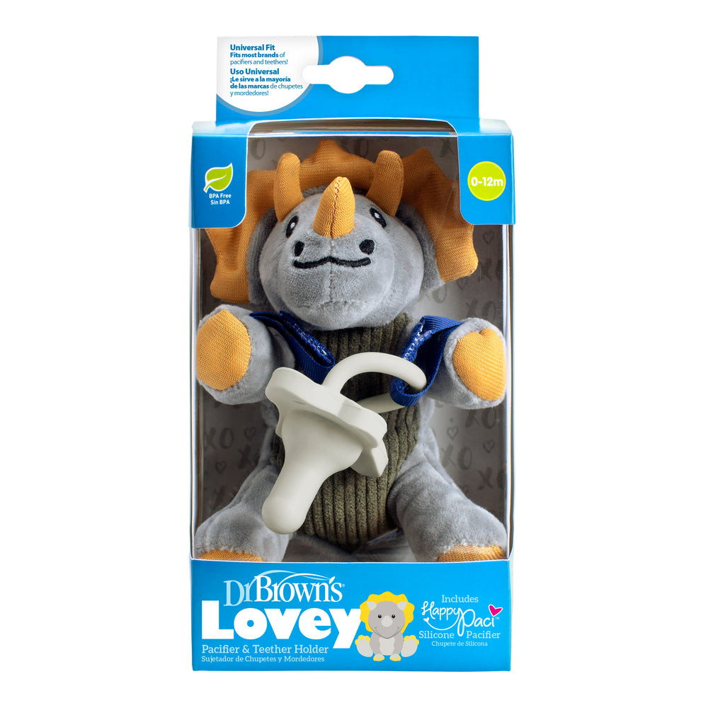 A boxed Dr. Brown’s® Lovey Pacifier and Teether Holder, Triceratops, featuring a plush triceratops toy that serves as both a pacifier and teether holder. The blue packaging emphasizes the inclusion of a silicone pacifier, suitable for ages 0-12 months.