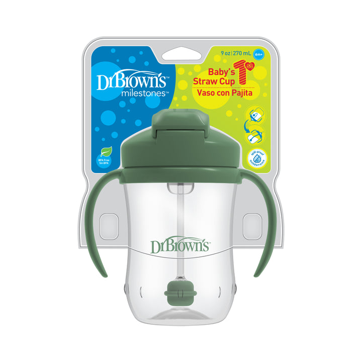 The Dr. Brown’s™ Milestones™ Baby’s First Straw Cup by Dr. Brown's, equipped with a weighted straw, holds 9 oz and includes a green lid and handles. It is intended for babies aged 6 months and older and comes with packaging in both English and Spanish.