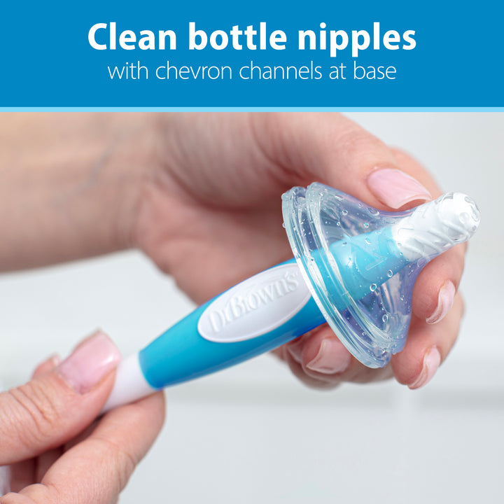 An individual holds the Dr. Brown’s Natural Flow® Baby Bottle Brush from Dr. Brown's, featuring a blue and white design with chevron channels at the base, specifically crafted for efficiently cleaning bottle nipples.