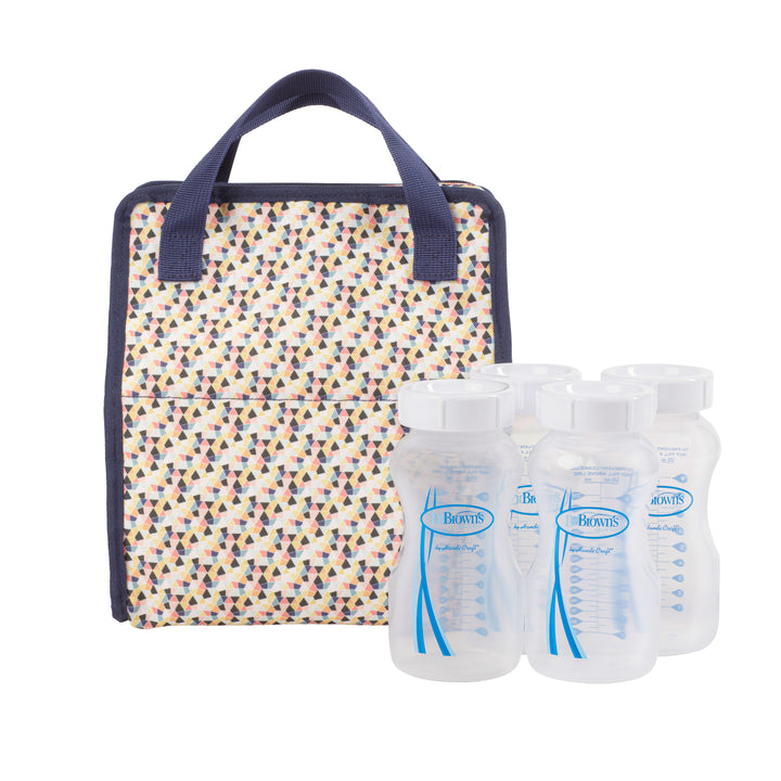 The Dr. Brown’s™ Fold & Freeze Bottle Tote, featuring navy handles and a patterned design, is placed next to four clear plastic baby bottles with measurement markings, providing an efficient way to organize your breast milk cooler essentials.