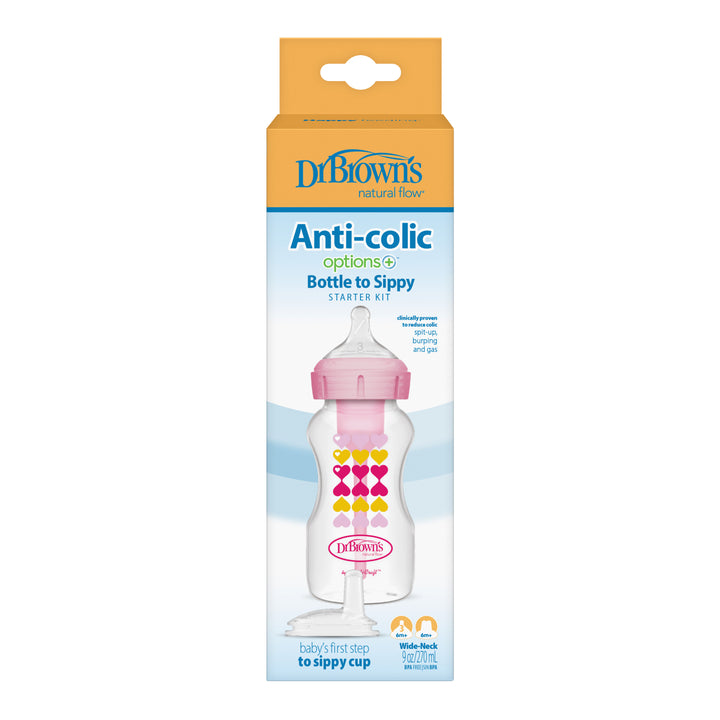 The Dr. Brown’s Natural Flow® Anti-Colic Options+™ Wide-Neck Sippy Bottle Starter Kit, 9oz/270mL, includes a pink-capped anti-colic baby bottle adorned with colorful hearts. Enclosed within the yellow, white, and blue packaging is a silicone sippy spout designed for an easy transition. The packaging showcases detailed product information and the Dr. Brown's branding.