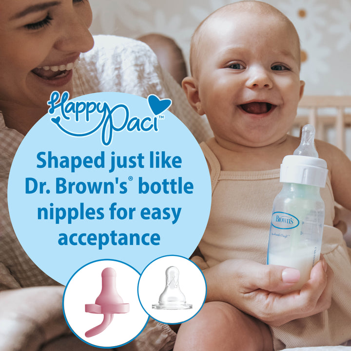 A content baby with a bottle is seated on a woman's lap, showcasing Dr. Brown's® HappyPaci™ 100% Silicone One-Piece Pacifier. The image highlights its comforting design, reminiscent of Dr. Brown's bottle nipples for easy acceptance, featuring visuals of the silicone pacifier and nipple to emphasize this gentle innovation.