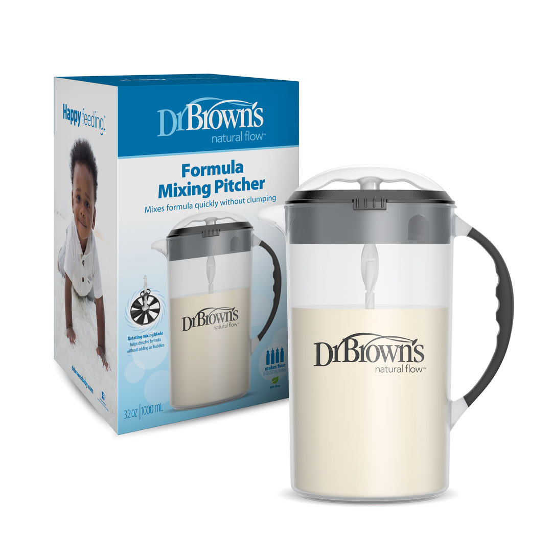 Dr. Brown's Natural Flow® Formula Mixing Pitcher is shown with its packaging, filled with a creamy liquid. It includes a handle and lid and is ideal for preparing baby bottles, as the design aids in reducing gas. The box features an image of a baby along with key product details from Dr. Brown's brand.