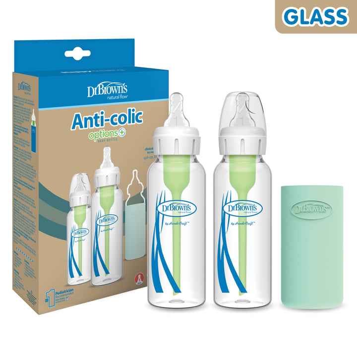 Image of Dr. Brown’s Natural Flow® Anti-Colic Options+™ Narrow Glass Baby Bottle with Silicone Sleeve, 2-Pack, featuring the innovative design with two bottles equipped with green internal vents and silicone sleeves. The packaging box on the left highlights the "Options+" feature, while a separate mint-colored sleeve is shown on the right.