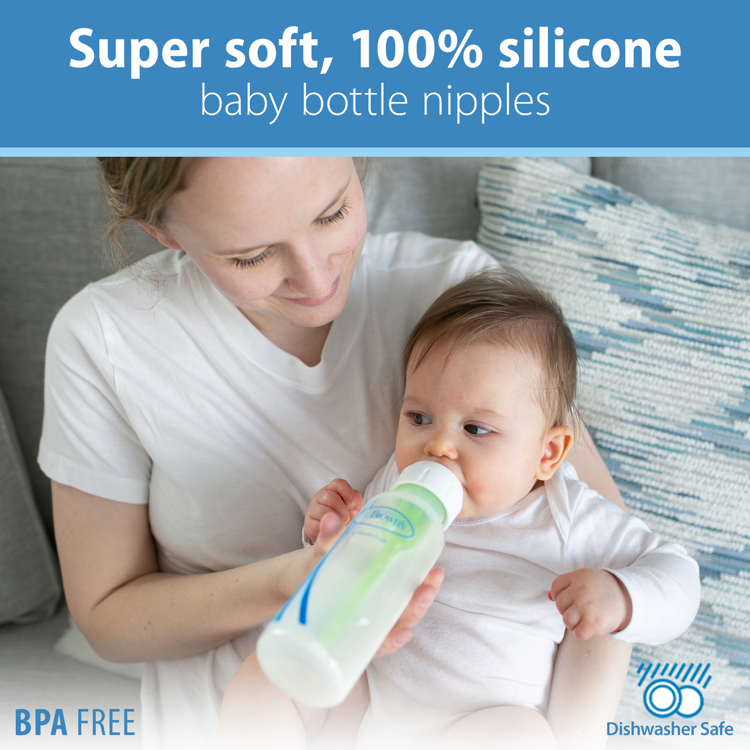 A woman is feeding a baby with a Dr. Brown’s Natural Flow® Narrow Baby Bottle Silicone Nipple from a 2-pack, which showcases qualities such as "super soft, 100% silicone," "BPA free," and "dishwasher safe." They are comfortably seated indoors on a couch, highlighting both comfort and quality.