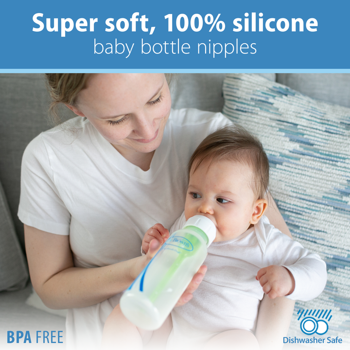 A woman is feeding a baby with a Dr. Brown’s Natural Flow® Narrow Baby Bottle Silicone Nipple from a 2-pack, which showcases qualities such as "super soft, 100% silicone," "BPA free," and "dishwasher safe." They are comfortably seated indoors on a couch, highlighting both comfort and quality.