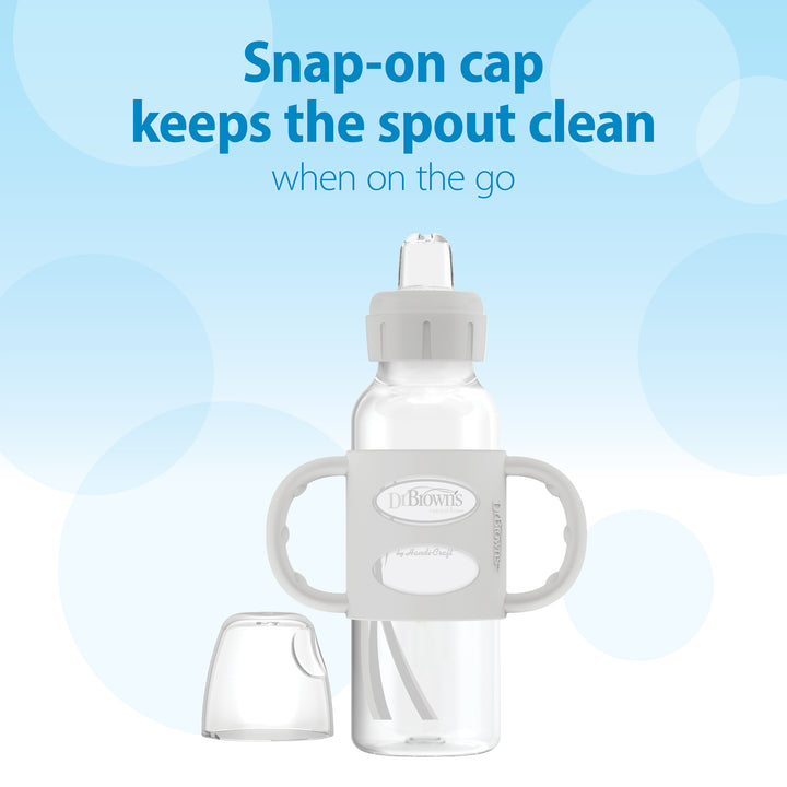 Dr. Brown's Dr. Brown’s® Milestones™ Narrow Sippy Spout Bottle with Silicone Handles, 8 oz/250 mL, features dual silicone handles and a snap-on cap to keep the spout clean during travel. The text above states, "Snap-on cap keeps the spout clean when on the go," set against a blue background with circular patterns.