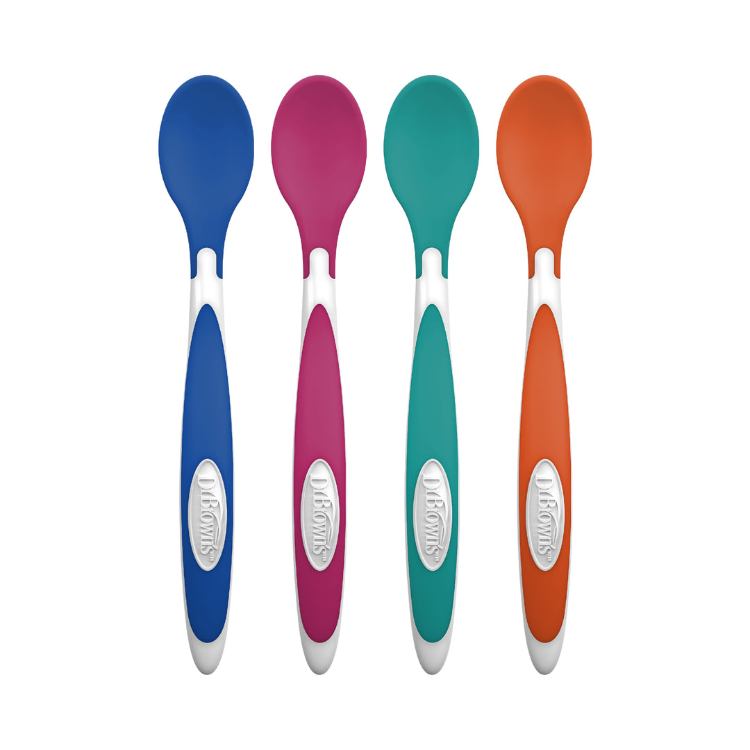 A set of four vibrant Dr. Brown's™ Designed to Nourish™ TempCheck Spoons, showcasing colors of blue, pink, teal, and orange with white handle grips embossed with the Dr. Brown's brand logo. Ideal for ensuring baby's food is at a safe temperature, these spoons are pictured standing vertically side by side against a white backdrop.