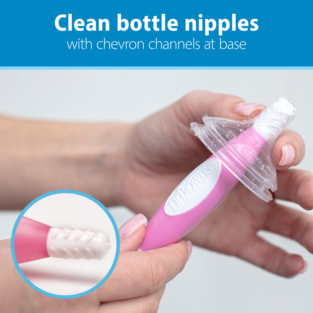 A parent-favorite tool, the Dr. Brown’s Natural Flow® Baby Bottle Brush, available in pink, is an ideal bottle brush with chevron channels at the base for cleaning bottle nipples. Text above reads: "Clean bottle nipples with chevron channels at base.