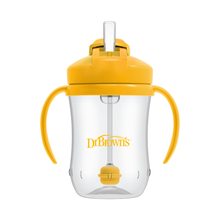 Introducing the Dr. Brown’s™ Milestones™ Baby’s First Straw Cup: a clear cup equipped with yellow handles and a spill-proof lid. It features a convenient flip-up straw, with "Dr. Brown's" proudly displayed on the front. This design is perfect for supporting your baby's transition from bottle to cup, featuring handy measurement markings on the side.