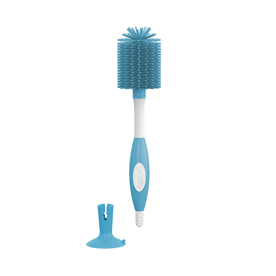 The Dr. Brown’s™ Soft Touch Bottle Brush by Dr. Brown's provides scratch-free cleaning with its durable, soft, rounded bristles in a blue and white design. It includes a matching blue stand and has a textured handle for a secure grip.