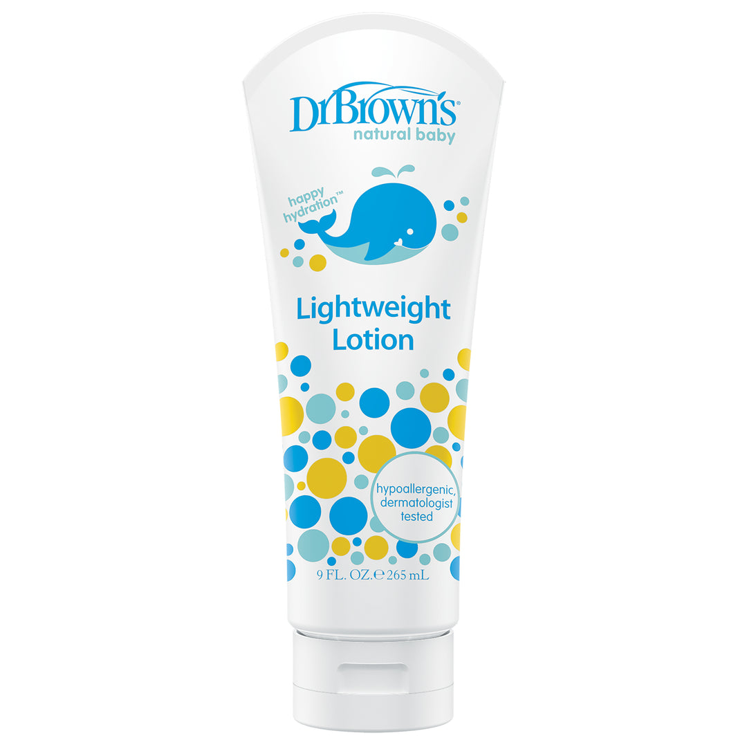 A 9 fl. oz. (265 ml) tube of Dr. Brown's Natural Baby Lightweight Lotion, featuring a playful blue whale and colorful circles design, is perfect for sensitive skin and proudly declares its dermatologist-tested hypoallergenic formula.