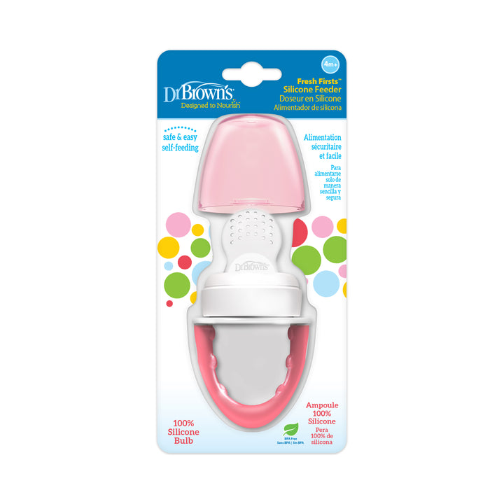 The packaging of Dr. Brown's™ Fresh Firsts™ Silicone Feeder highlights a pink and white silicone bulb, featuring a design that promotes safe and easy self-feeding for infants aged 6 months and older, all set against a colorful dotted background.