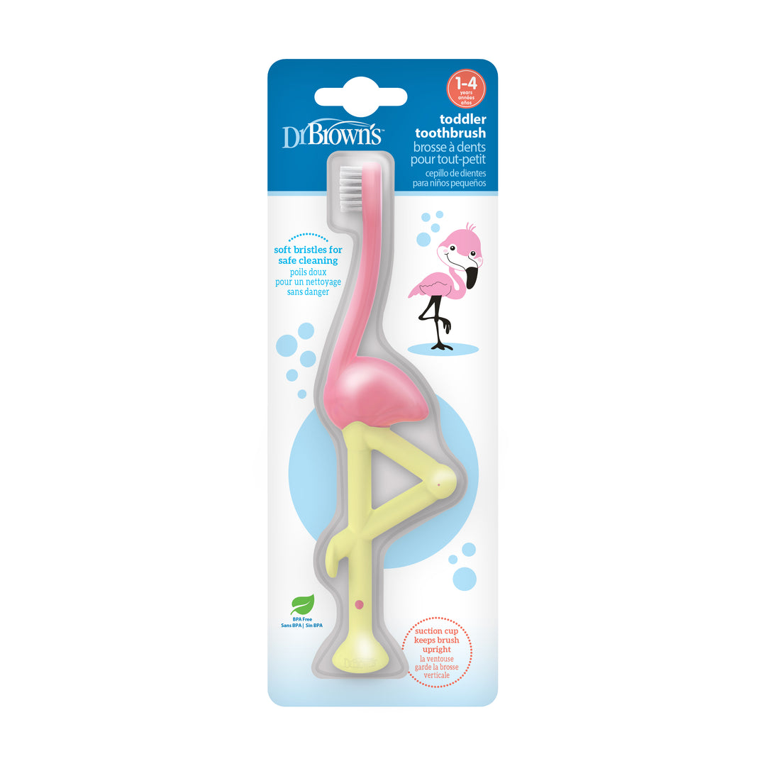 The Dr. Brown’s™ Toddler Toothbrush in a charming flamingo design features a vibrant pink handle and a white brush head. Designed for children aged 1-4, it ensures gentle cleaning with super-soft bristles and includes a handy suction-cup base for convenient storage.