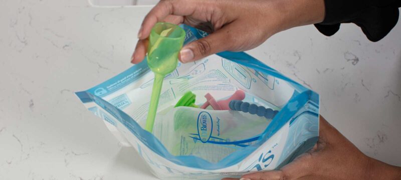Person putting items in Microwave Sterilizer Bag