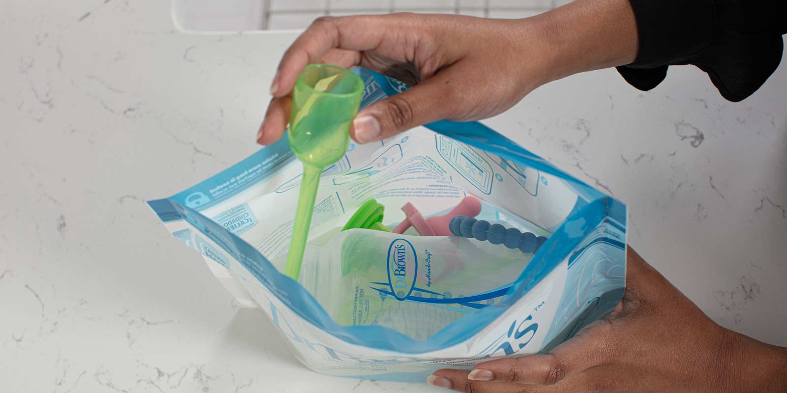 Person putting items in Microwave Sterilizer Bag