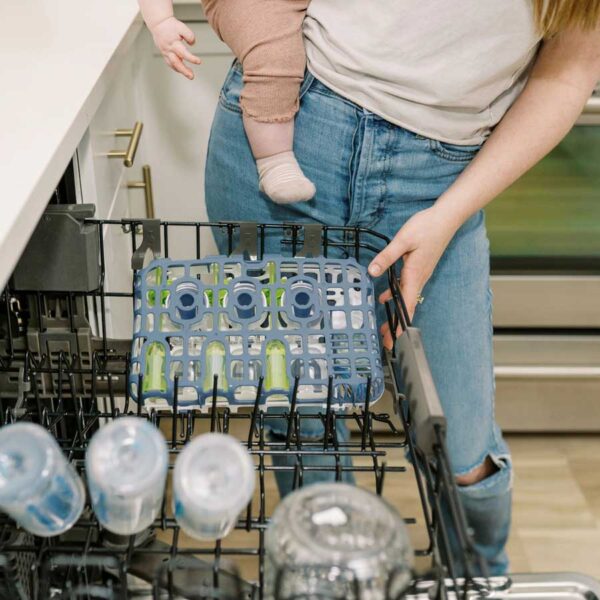 Parent putting in blue dishwasher basket